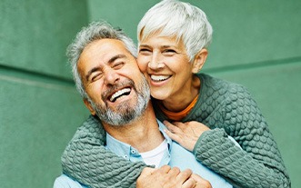 Couple smiling and hugging