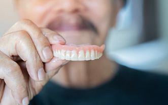 Glastonbury patient rinsing dentures after meal