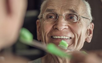Smiling Glastonbury patient with implant-supported dentures