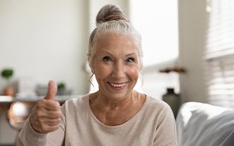 woman smiling after getting dental implants 