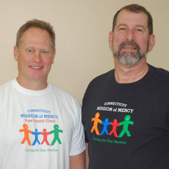 Doctors Heim and Carroll wearing Connecticut Mission of Mercy t-shirts