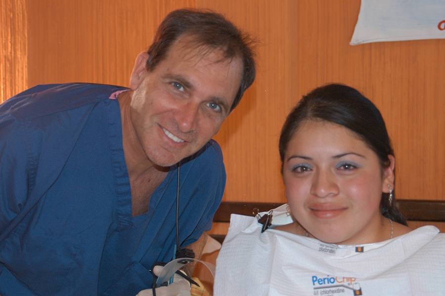 Dentist and patient smiling together