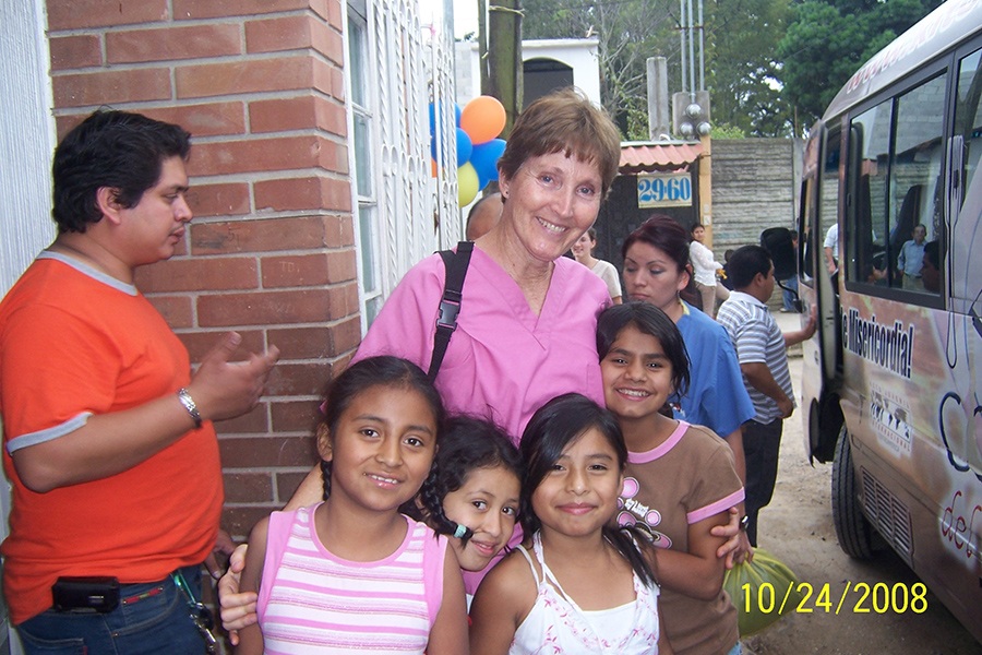 Dental team member smiling with group of young patients