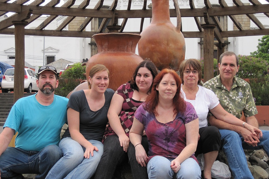 Group of dental team member in front of large statues