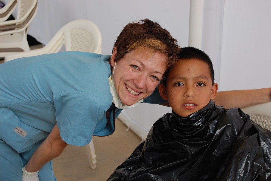 Dental eam member smiling with young patient