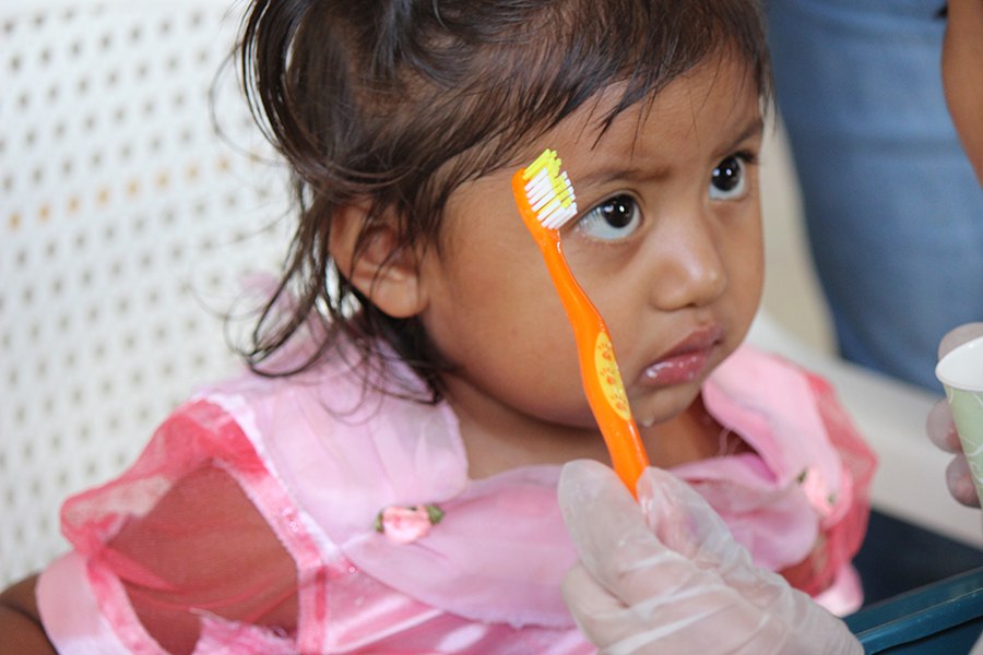 Young girl holding a toothbrush