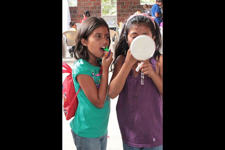 Two young patients flossing