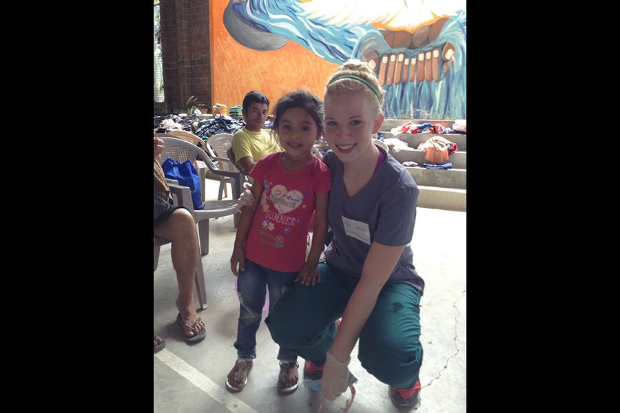 Dental team member and patient smiling together