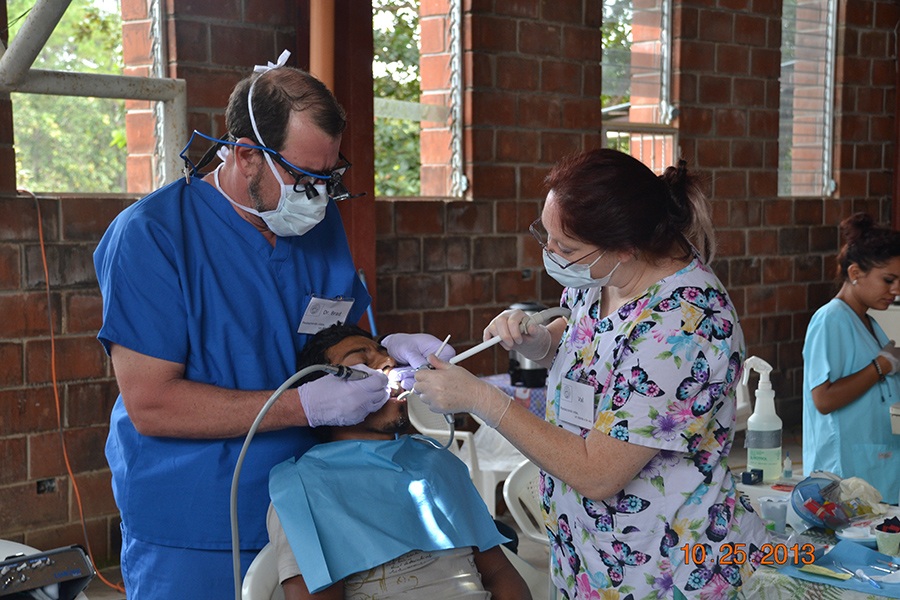 Dentist and team member caring for dental patient
