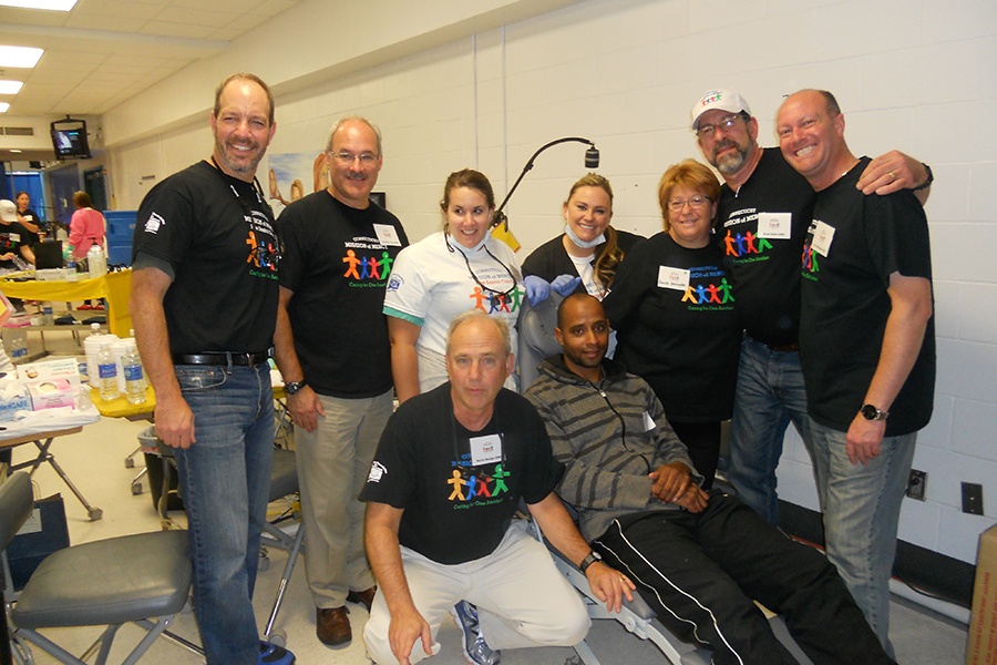 Group of dentists and dental team members wearing Connecticut Mission of Mercy shirts