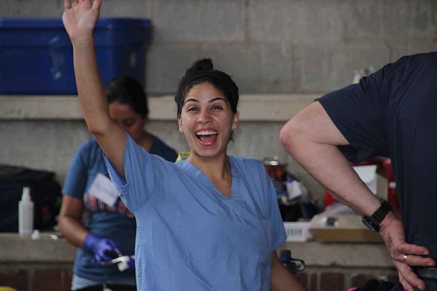 Happy dental team member waving