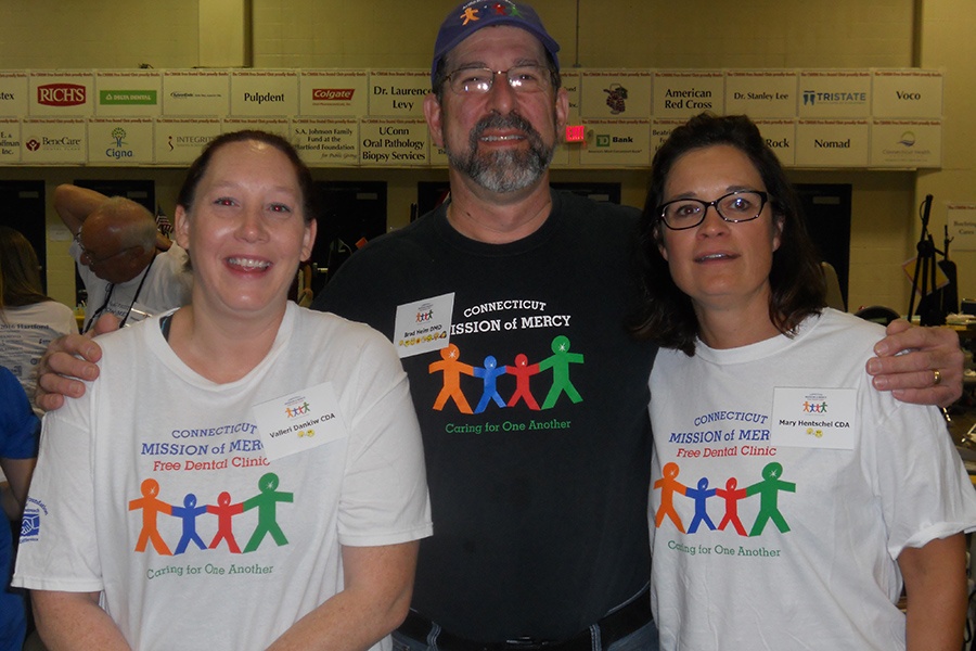 Three team members wearing Connecticut Mission of Mercy shirts