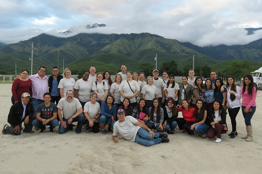 Group of team members in front of mountain range