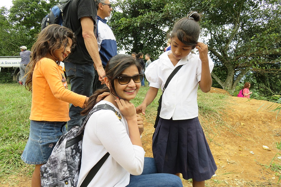 Smiling dental team member with two young dental patients