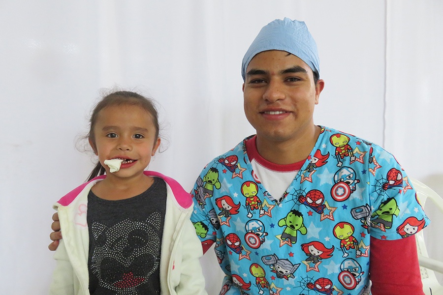 Dentist and patient smiling together after dental treatment