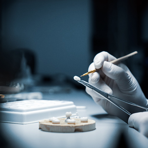 a dental professional working on dental crowns in Glastonbury