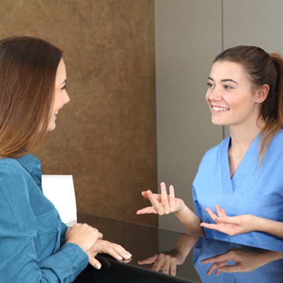 Employee explaining cost of emergency dentistry in Glastonbury