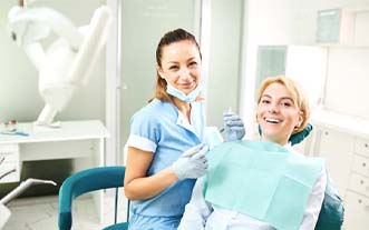 Woman preventing dental emergencies in Glastonbury by visiting dentist