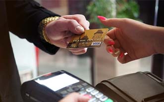 Man handing woman a credit card