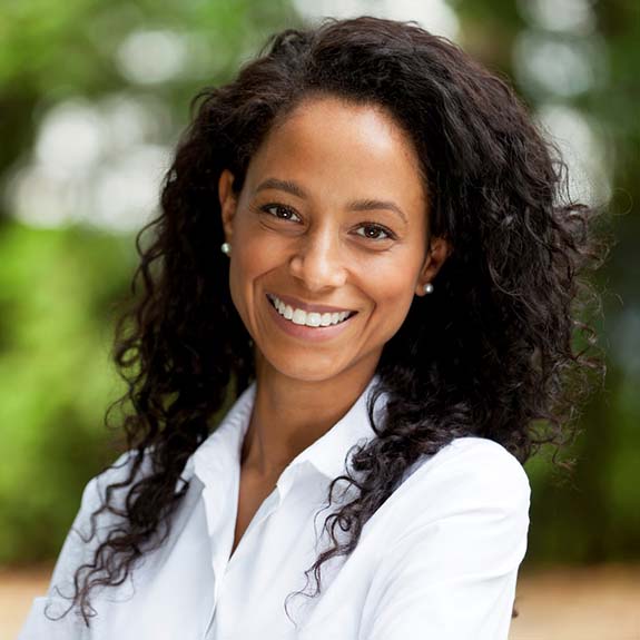 Smiling woman with dental implants in Glastonbury