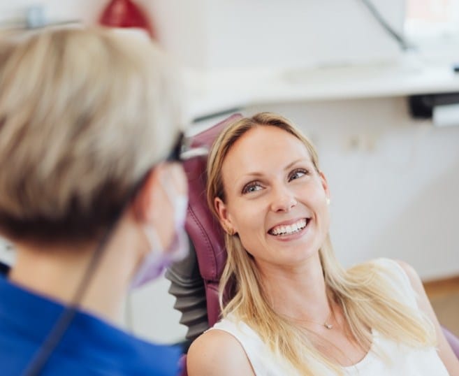 Dentist talking to dental patient in consultation room