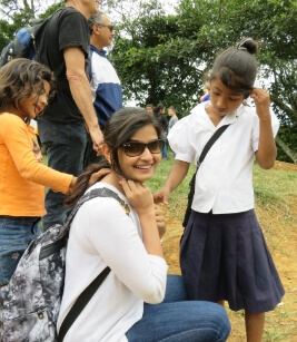 Team member and children at community event