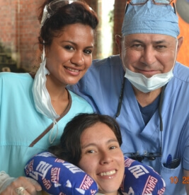 Dentist and team member providing dental treatment at community event