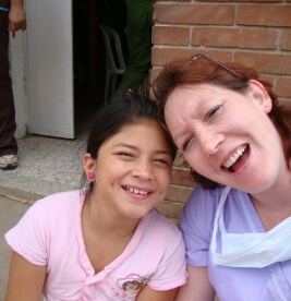 Dental team member and young dental patient at community event