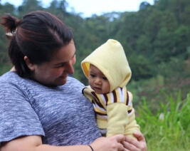 Woman holding a baby outdoors