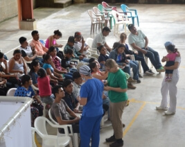 Dentist talking to group of people at community event