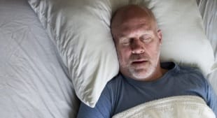 Man sleeping soundly thanks to sleep apnea therapy