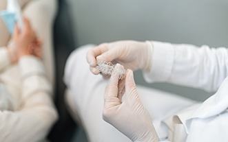 Dentist holding clear aligner