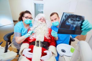 Santa looking at dental X-rays with his Glastonbury dentist